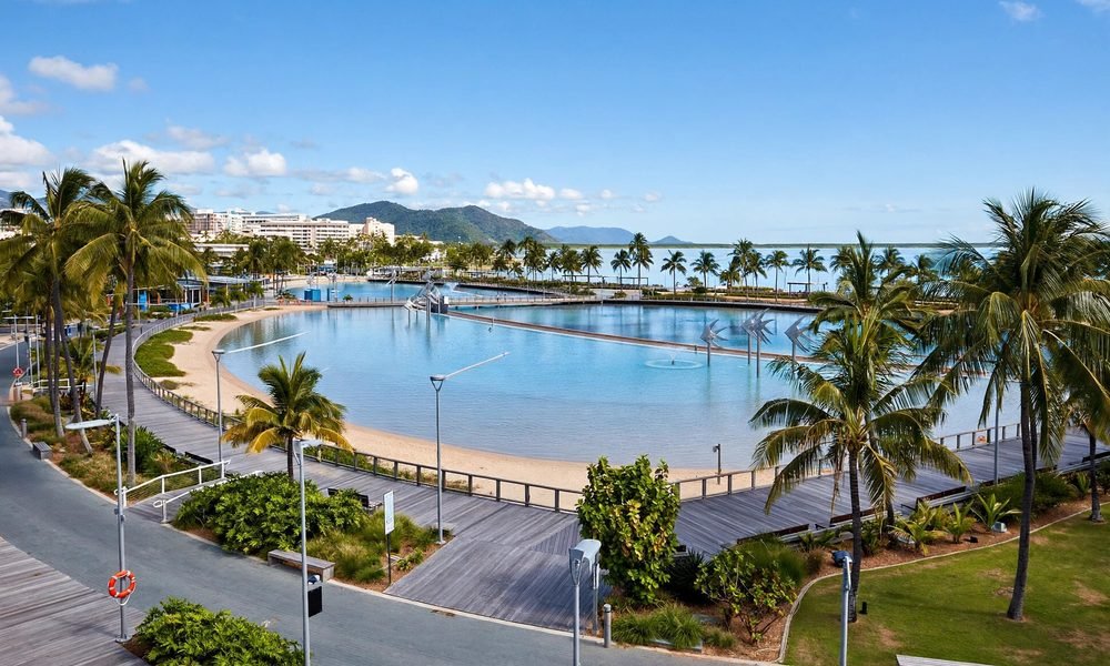 Cairns esplanade lagoon with palm trees and waterfront promenade in tropical Queensland