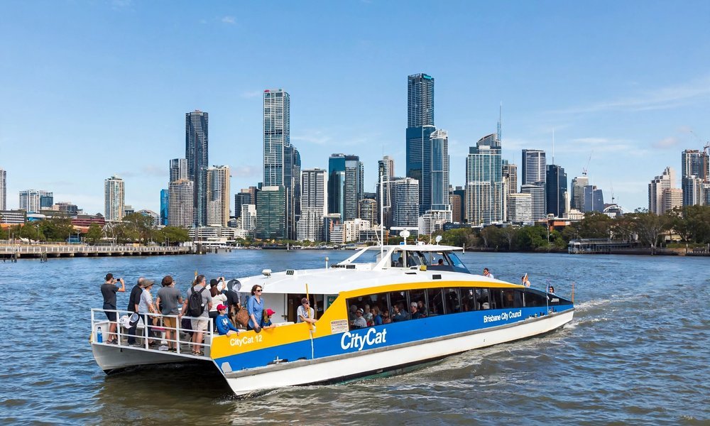 CityCat ferry cruising past the Brisbane city skyline on the river
