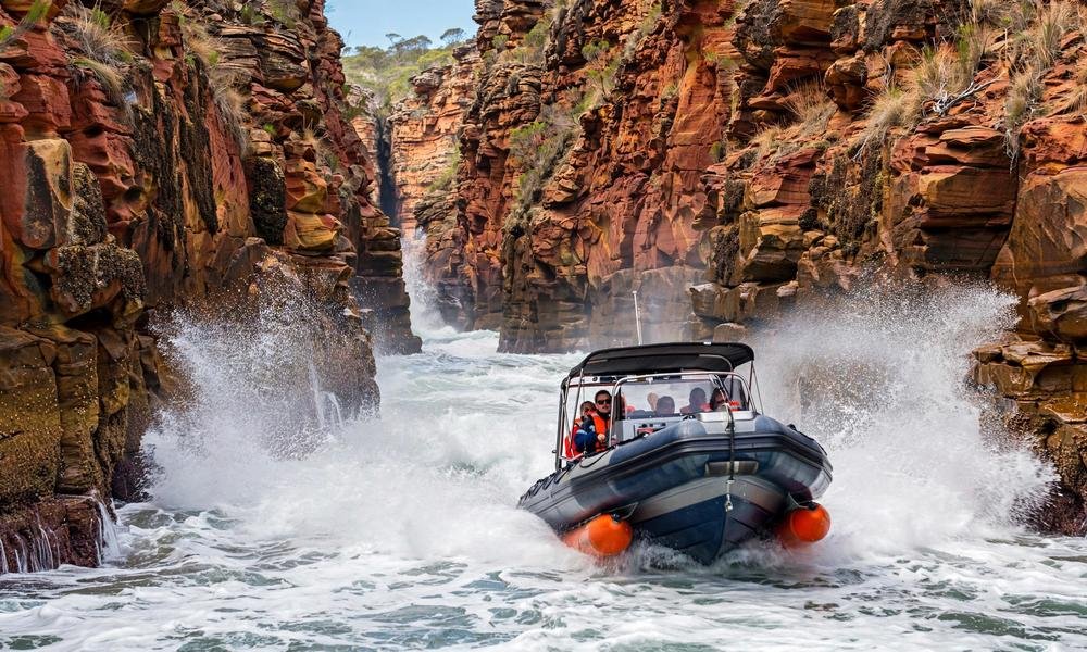 A fast boat races through the Wide Gap at Horizontal Falls, Talbot Bay, in the Kimberley