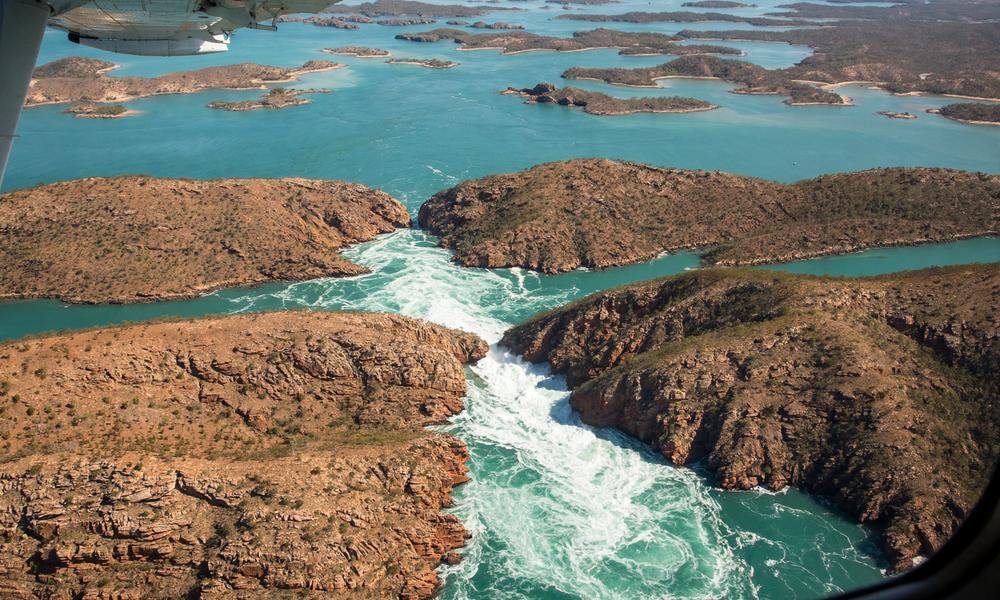 A seaplane flying low over Horizontal Falls in Talbot Bay, Kimberley, Western Australia