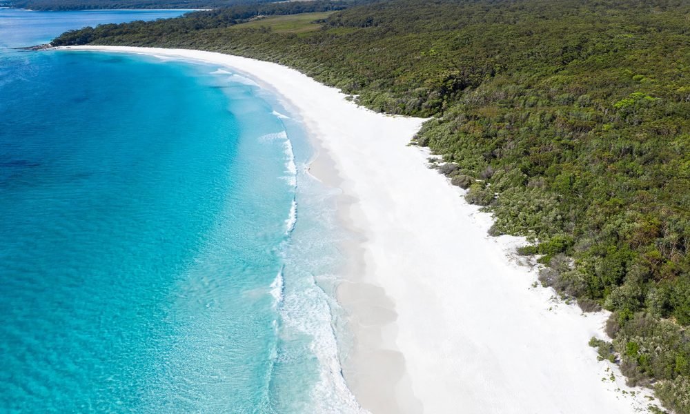 Aerial view of Hyams Beach in Jervis Bay with white sand and turquoise water