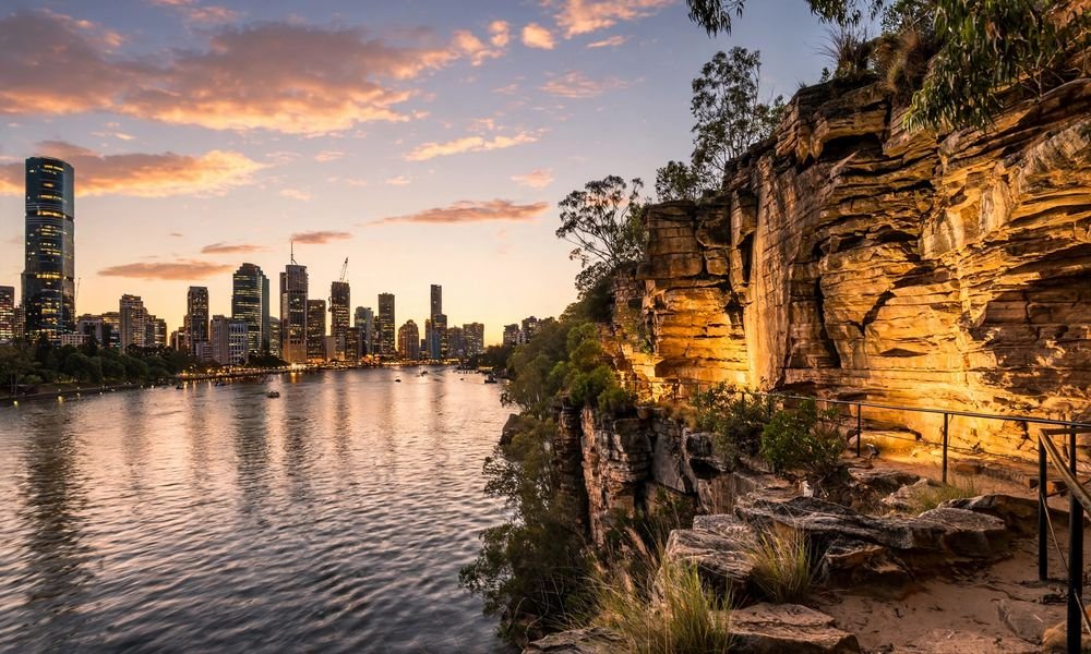 Kangaroo Point cliffs across the Brisbane River with the city skyline at dusk
