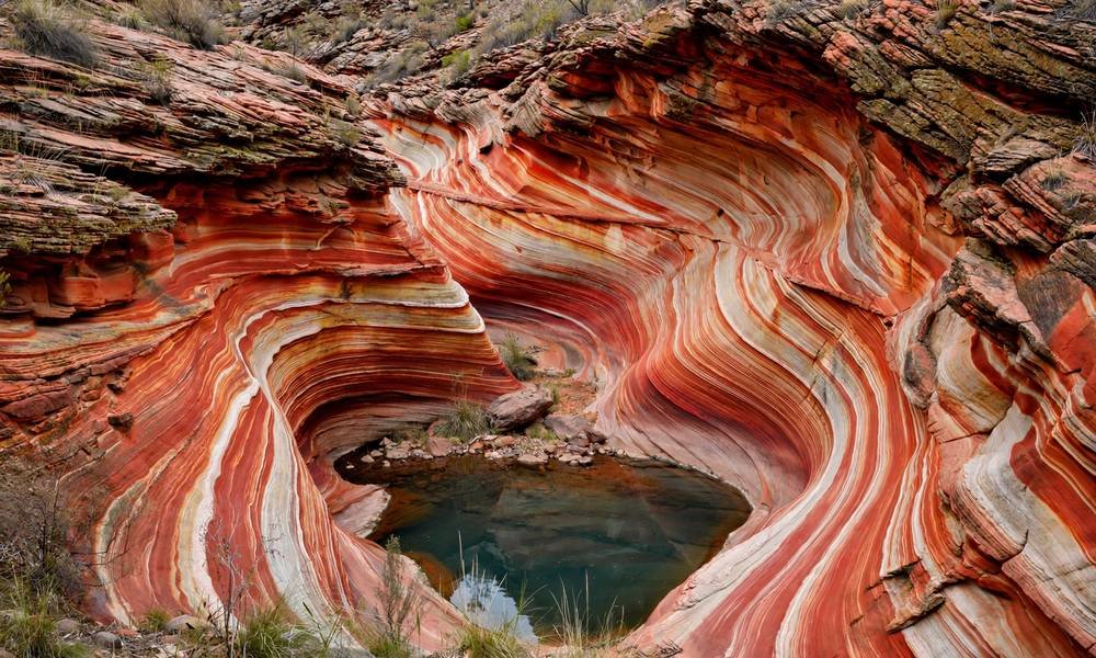 Swirling red and cream rock walls above the Spa Pool at Hamersley Gorge