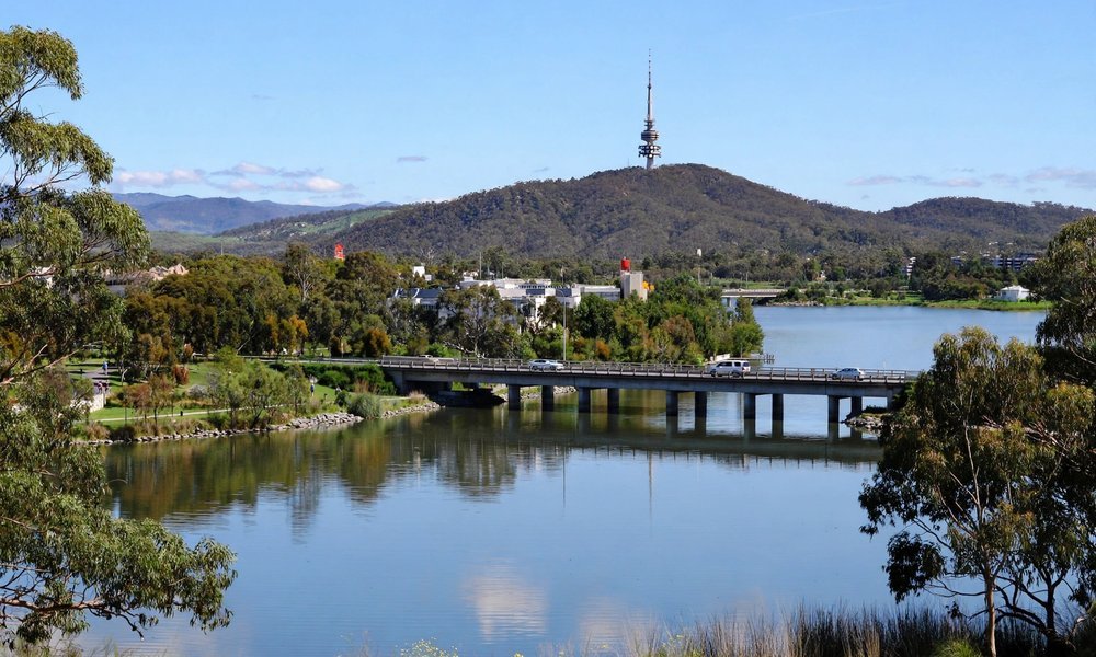 Lake Burley Griffin in Canberra with a bridge crossing the water and Black Mountain in the distance