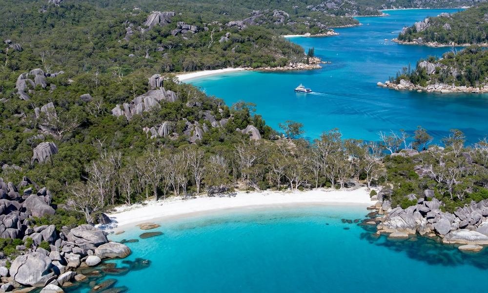 Aerial view of Magnetic Island, Queensland, with turquoise bay, granite boulders and a ferry crossing