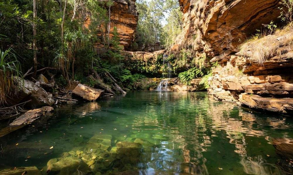 Maguk plunge pool surrounded by sandstone cliffs