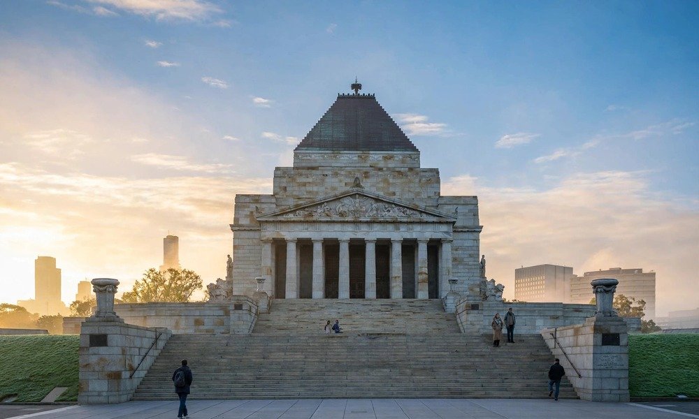 The Shrine of Remembrance in Melbourne at sunrise with the city skyline behind