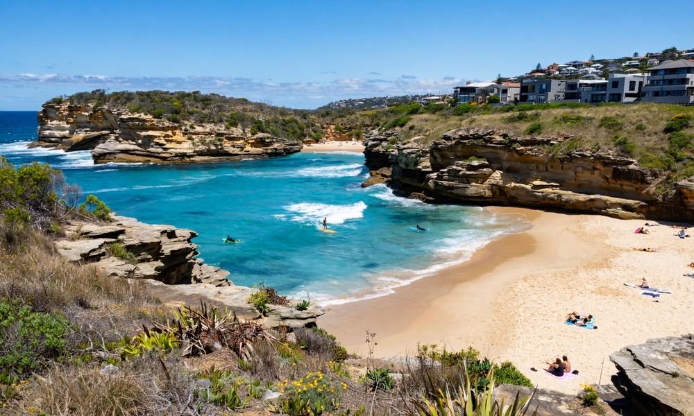 Tamarama Beach seen from the clifftop coastal walk, a small turquoise cove between sandstone headlands