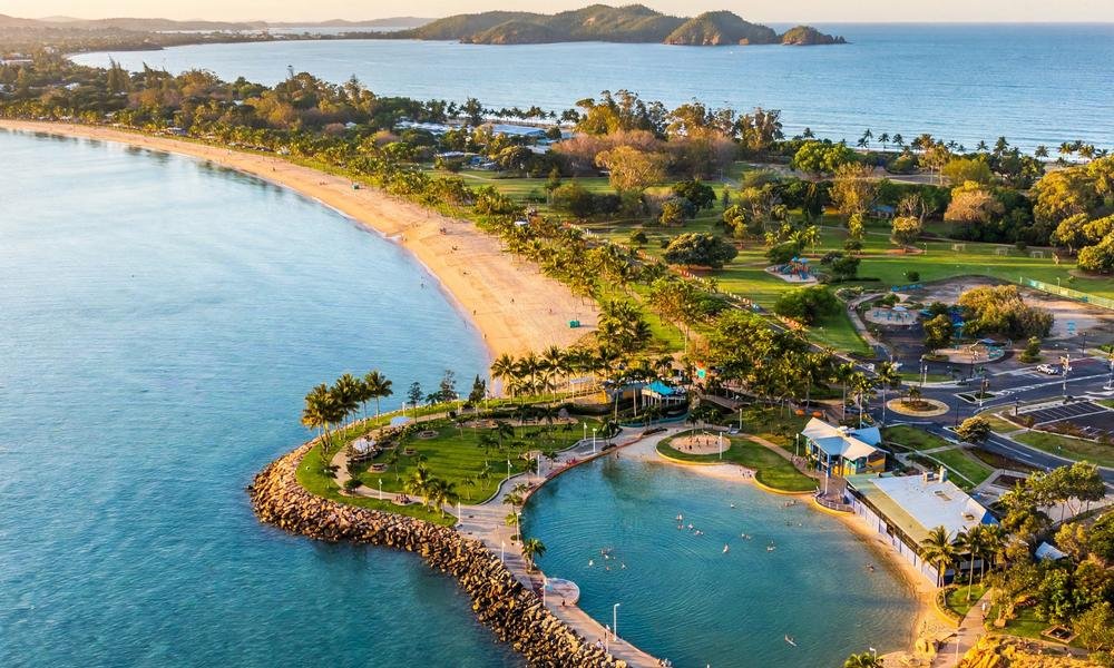 The Strand esplanade at sunset with palm trees and the waterfront in Townsville, North Queensland