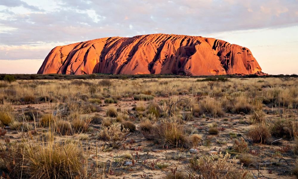 Uluru glowing at sunrise in Uluru-Kata Tjuta National Park, one of the best national parks in Australia